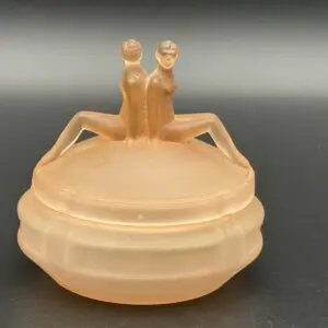 Vintage orange glass container with figures