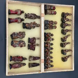 Intricate carved chess pieces in box