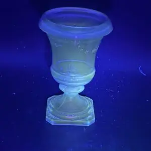 Glowing glass vase under ultraviolet light