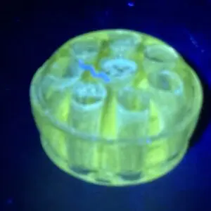 Yellow cylindrical shape, dark backdrop