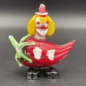 Clown-themed glass figurine with red chili