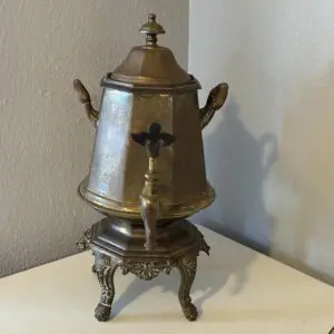 Elegant brass samovar on white surface